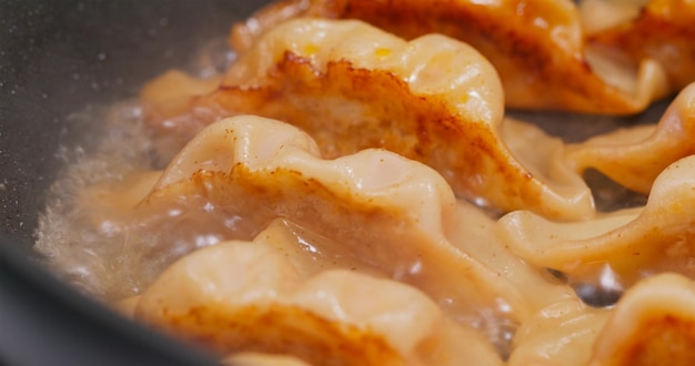 Fry meat dumpling on pan in kitchen