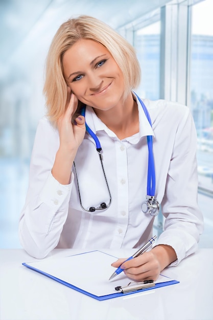 Fryendly female doctor at hte table