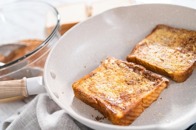 Frying french toast in a nonstick frying pan.