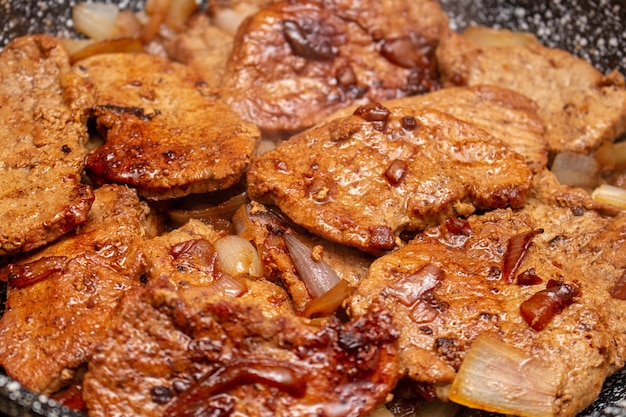 Frying meat in a pen with the steam