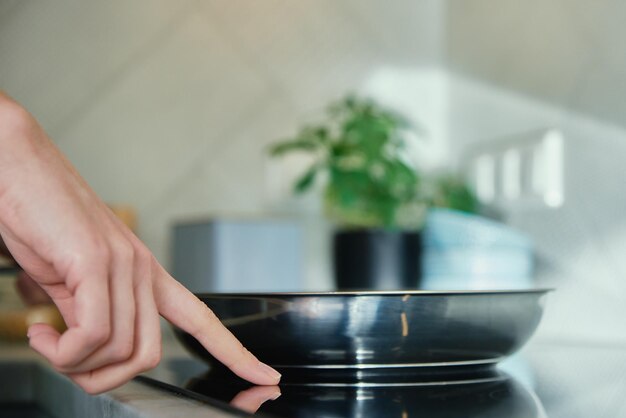 Frying pan on induction hob at kitchen