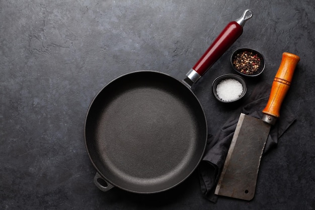 Frying pan utensils and ingredients on kitchen table