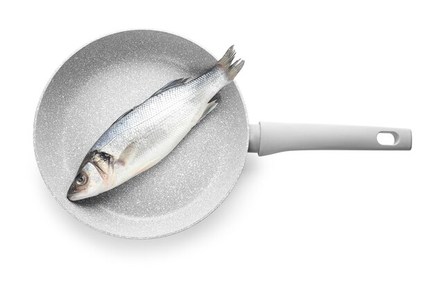 Frying pan with raw fish on white background