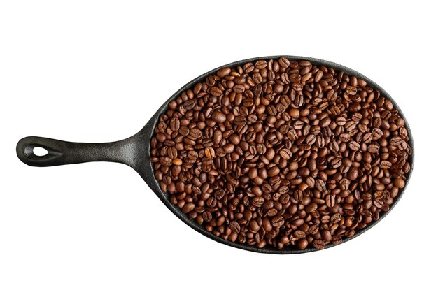 Frying pan with roasted coffee beans isolated on white background