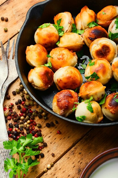 Frying pan with roasted tasty pelmeni.Fried dumplings