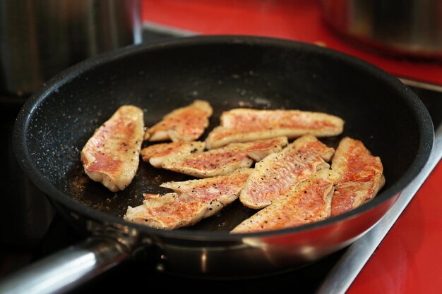 Frying red mullet fish fillets