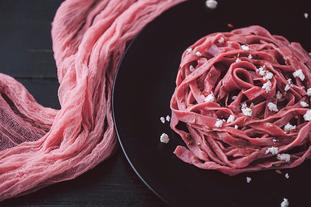 Fuchs delicacy pasta with home-made beet juice, cranberries, essences of French wine with feta cheese and flax seed