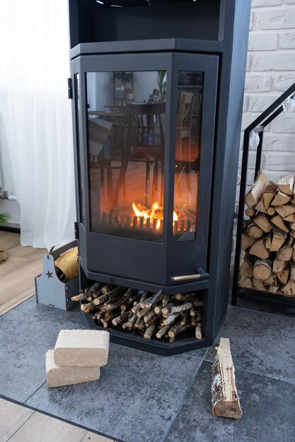 炉を燃やすための圧縮されたおがくずで作られた燃料ブリケット 家の暖炉のための経済的な代替環境に優しい燃料 薪は内部のオーブンで燃えています