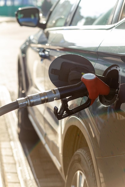 Fuel nozzle to refill fuel in car at gas station