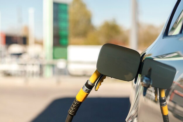 Fuel pistol in the car tank Car at the gas station