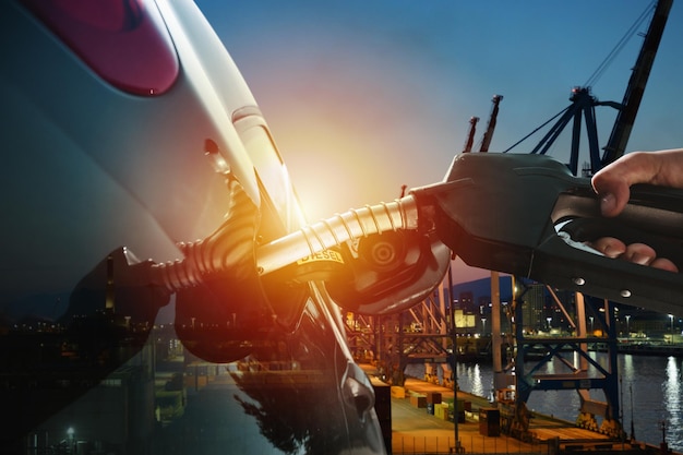 Photo fuel pump fill a tank of a car in a station