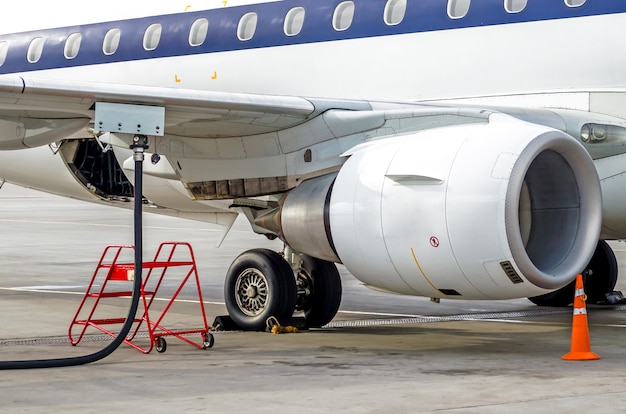 Fueling aircraft, view of the wing, hose, engine. Airport Service.