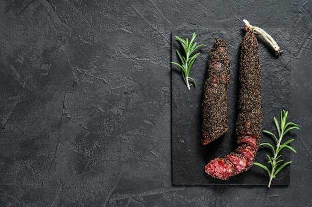 Fuet, Salami and a sprig of rosemary.