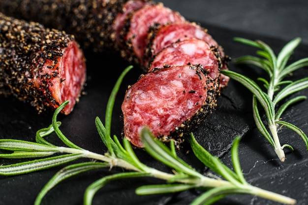 Fuet, Salami and a sprig of rosemary. 