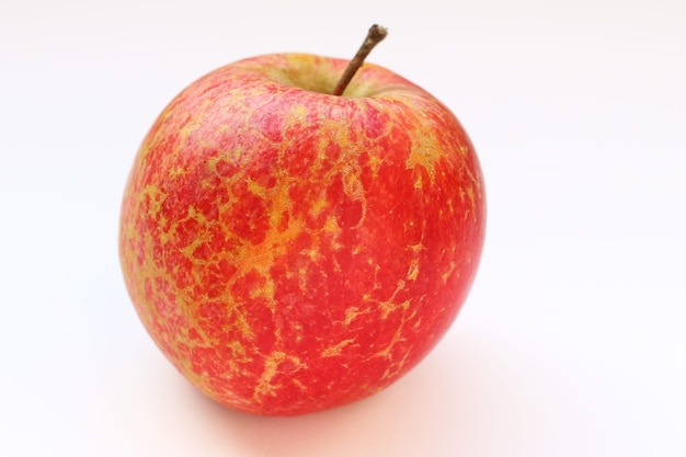 Fuji apple on a white surface
