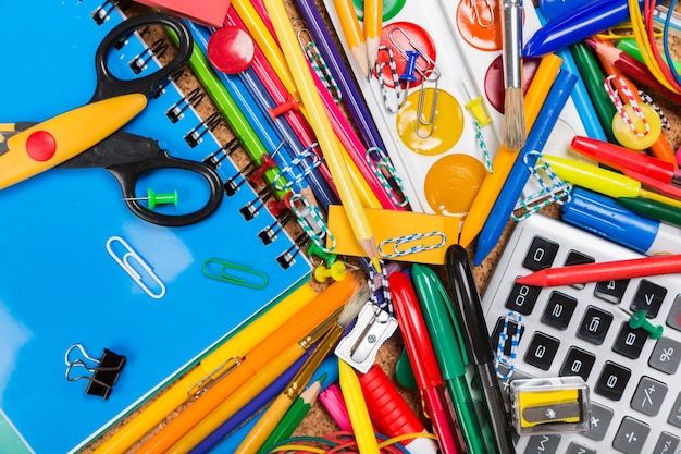 Photo full background of a colorful assortment of school supplies