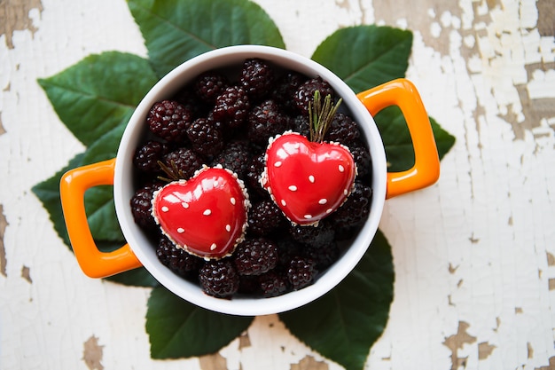 A full blackberry plate with heart-shaped dessert