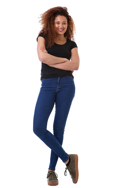 Full body happy woman with curly hair standing against isolated white background