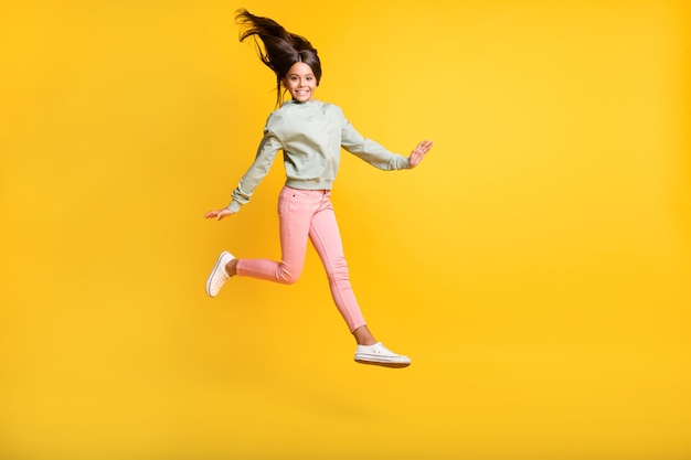 Full body portrait of school person jumping hair fly happiness isolated on bright yellow color background