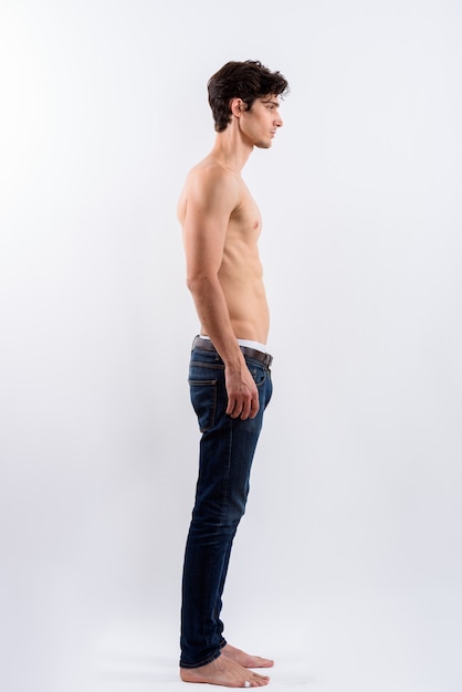 Full body shot of profile view of young handsome man standing