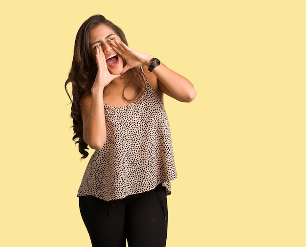Full body young curvy plus size woman shouting something happy to the front