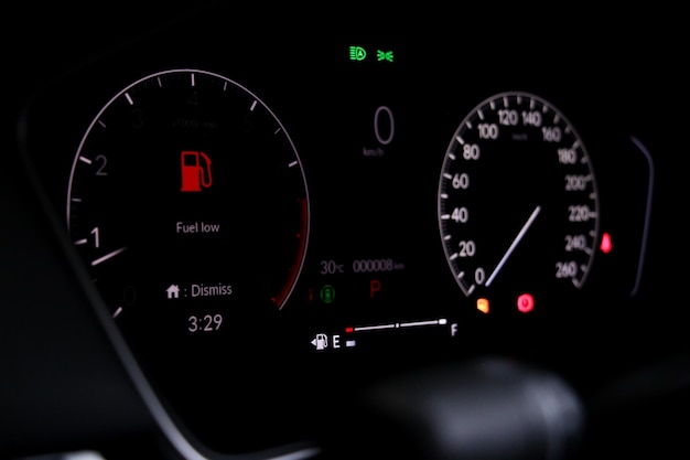 Full digital car miles or speed of meter with oli low fuel
level warning light icon symbol on dashboard. transportation
concept.