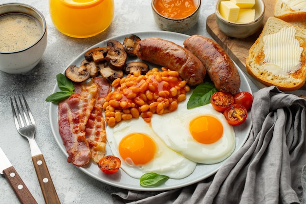 Full English breakfast on a plate with fried eggs