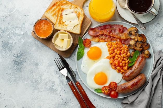 Full English breakfast on a plate with fried eggs