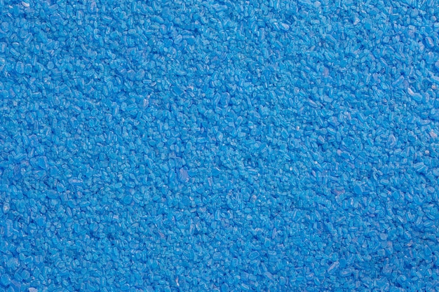 Full frame background and texture of blue copper sulfate granules closeup