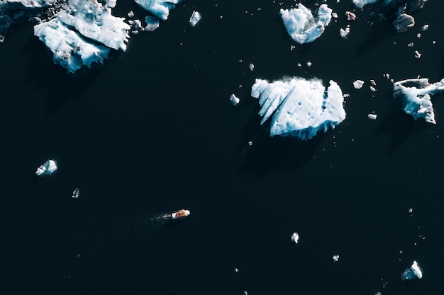 Full frame of boat navigating between icebergs