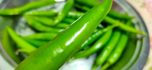 Full frame close up of a bunch of bright and shiny green chili p