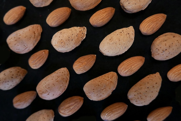 Photo full frame shot of almonds over black background