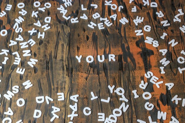 Photo full frame shot of alphabets on wooden table