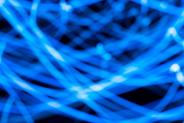 Full frame shot of blue illuminated fiber optics against black background