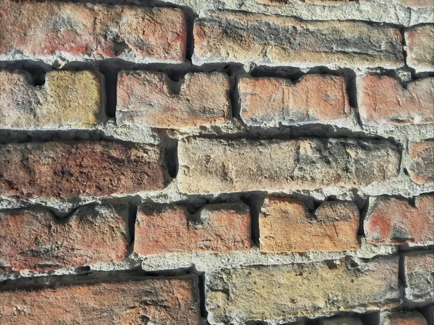 Foto fotografia completa di un muro di mattoni in una giornata di sole