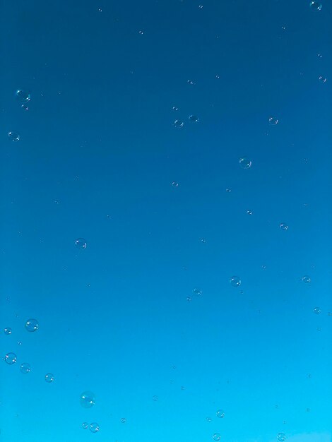 Full frame shot of bubbles against blue sky