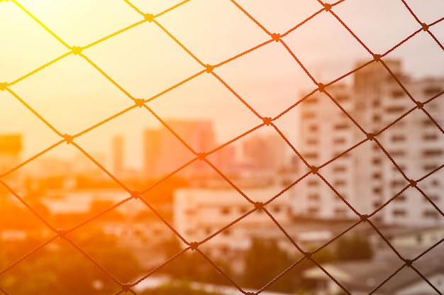 Full frame shot of chainlink fence against wall