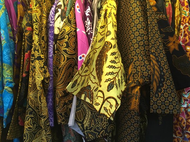 Full frame shot of colorful clothes hanging on rack in store