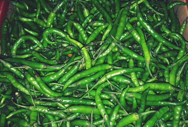 Full frame shot of green chili peppers at market stall