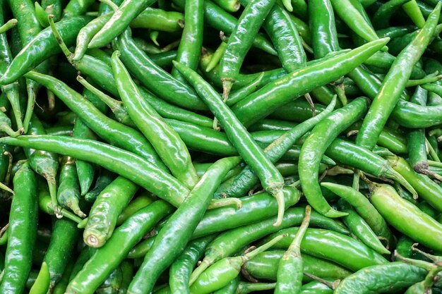 Full frame shot of green chili peppers for sale in market