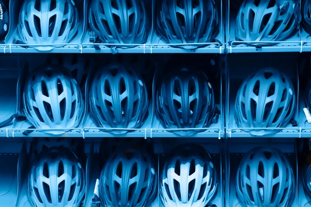 Photo full frame shot of helmets on shelves for sale in store