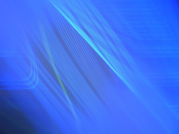 Full frame shot of light painting against blue background