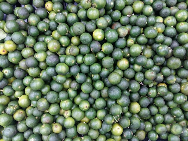 Full frame shot of limes for sale at market