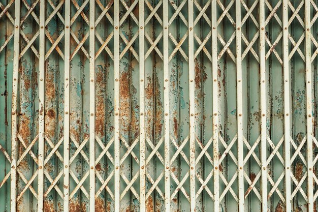 Photo full frame shot of metal fence against wall