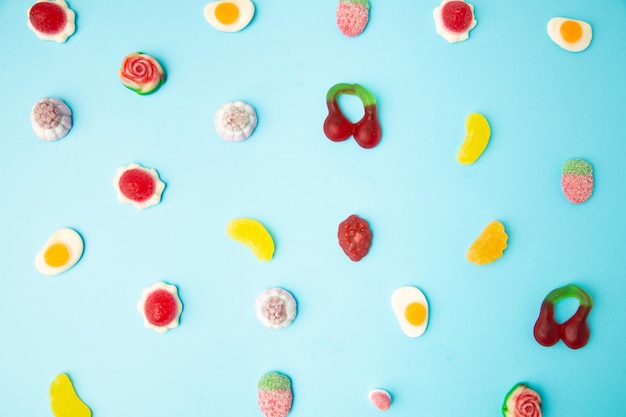 Photo full frame shot of multi colored candies against blue background