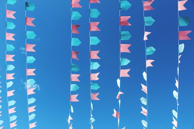 Photo full frame shot of multi colored flags against blue sky