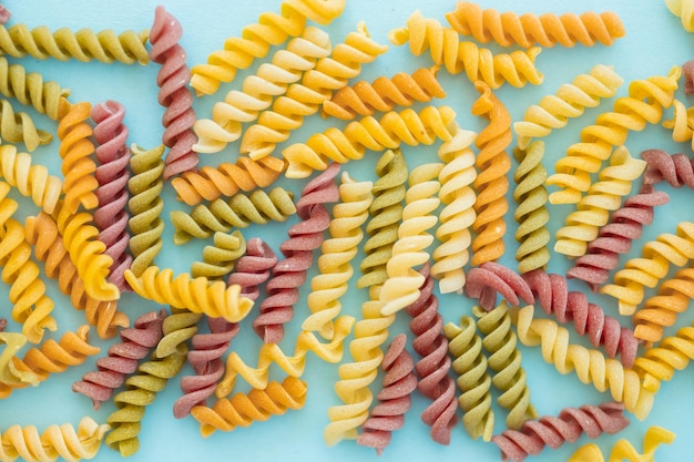 Full Frame Shot Of Multi Colored Pasta on blue background