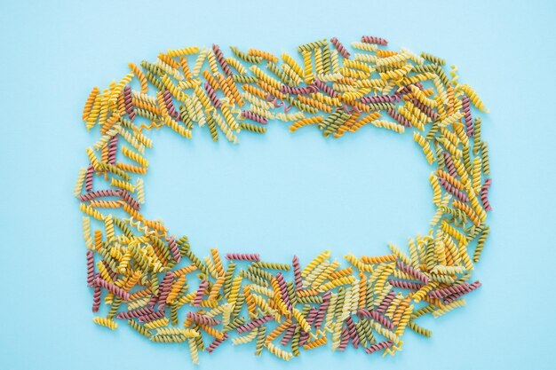 Full Frame Shot Of Multi Colored Pasta on blue background