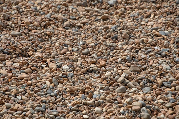 Foto fotografia completa di ciottoli sulla spiaggia