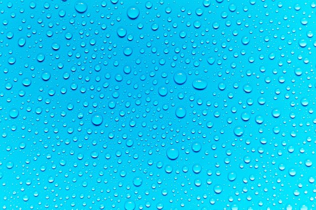 Full frame shot of raindrops on blue surface